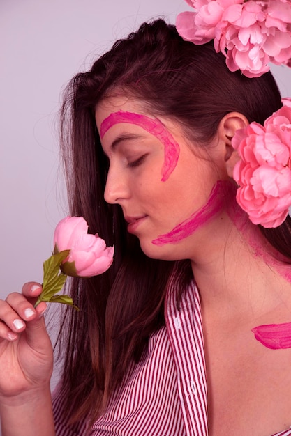 Woman with pink peonies in her hair