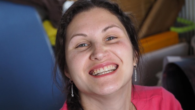 A woman with a pink shirt that has a big smile on it