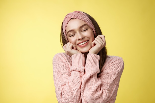 Woman with pink sweater over yellow