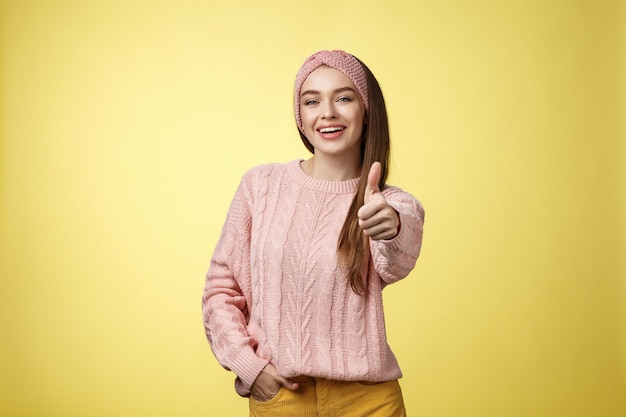 Woman with pink sweater over yellow