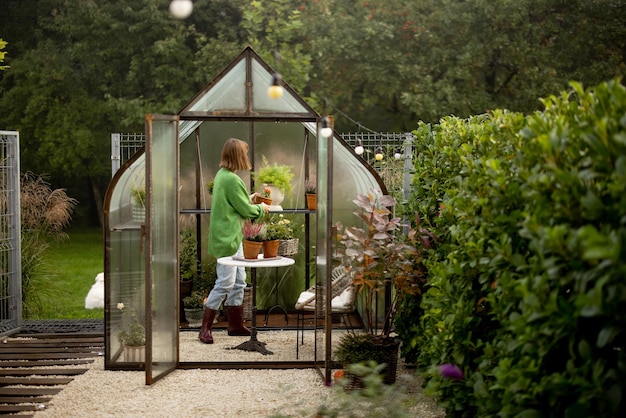 Woman with plants in greenhouse