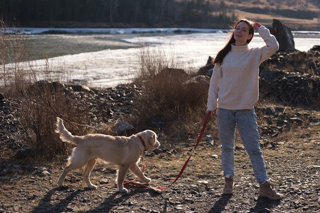 woman with a puppy in the mountains