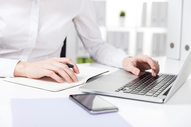 Woman with purple paper typing