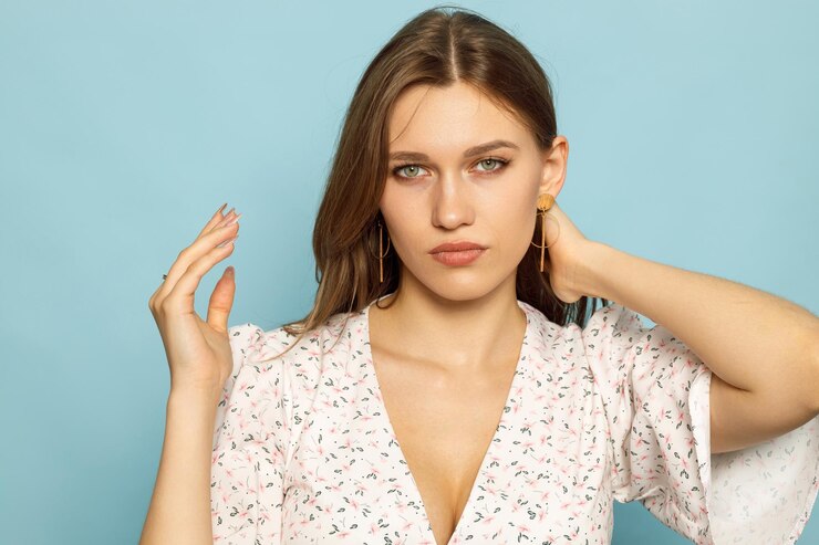 a woman with a red eye and a white shirt on