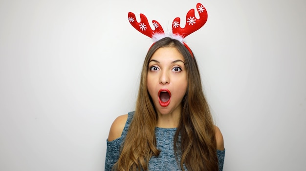 Woman with reindeer horns on her head with mouth open 