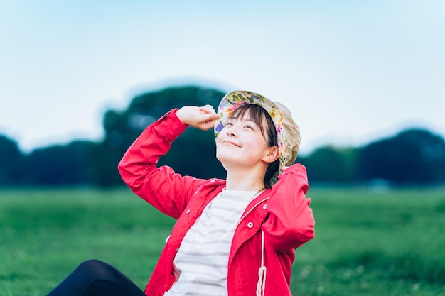 A woman with a relaxed look on the meadow