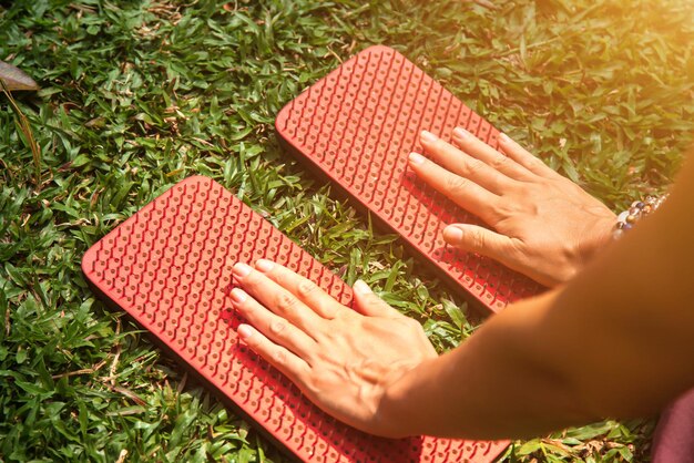 Woman with Sadhu board with nails on grass lawn outdoors