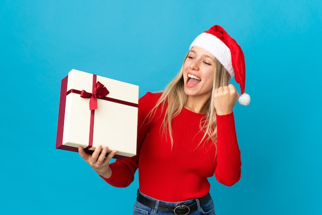 woman with santa hat holding gift box