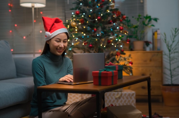 woman with santa hat using laptop