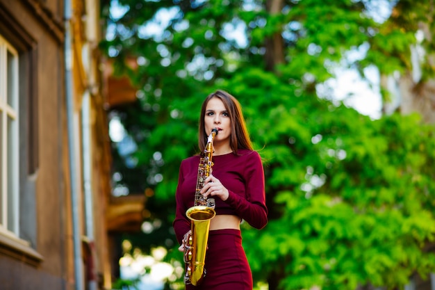 Woman with saxophone on street