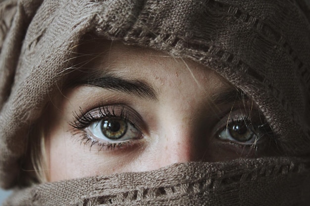 A woman with a scarf covering her eyes