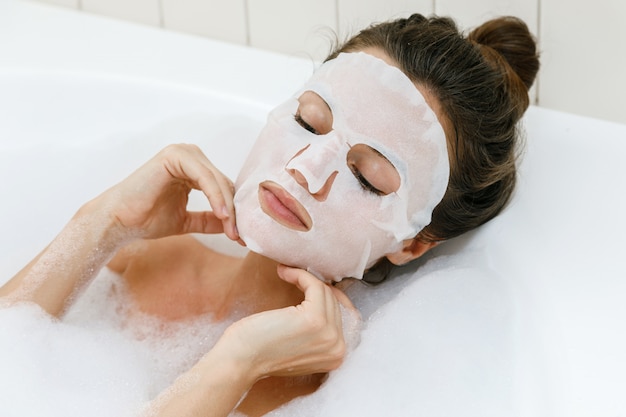 Woman with sheet mask on her face