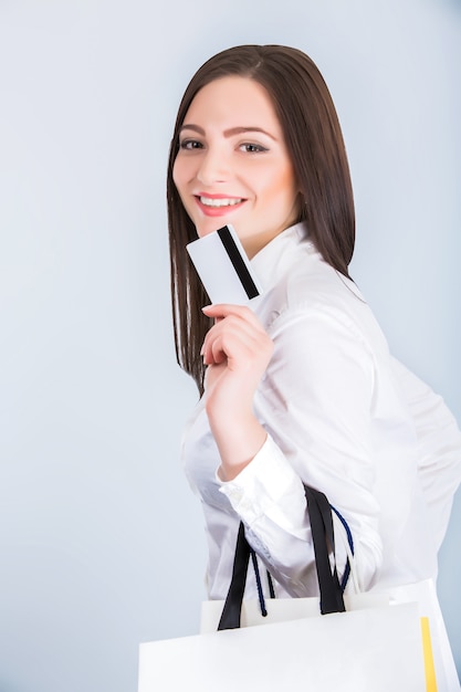 Woman with shopping bags and credit card