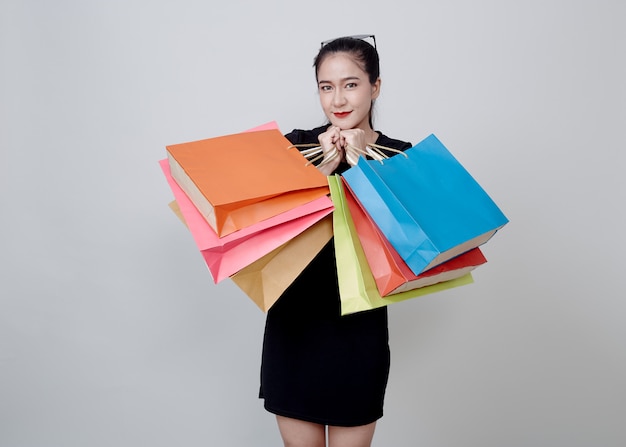 Woman With Shopping Bags Standing On White