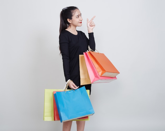 Woman With Shopping Bags Standing On White