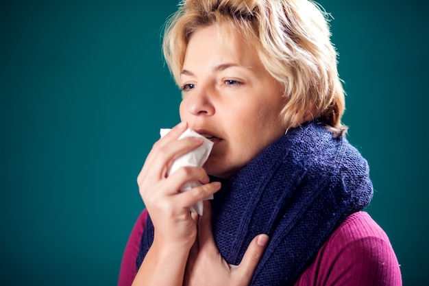 Woman with short blond hair got the flu and coughing. People, healthcare and medicine concept