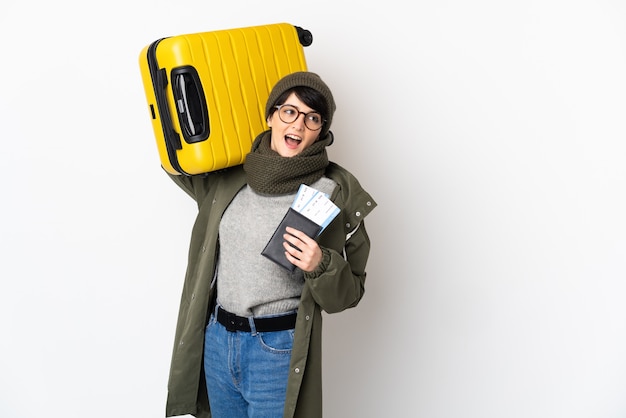 Woman with short hair over in vacation with suitcase and passport