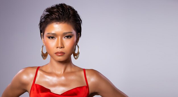 Woman with short hair wears red gown dress