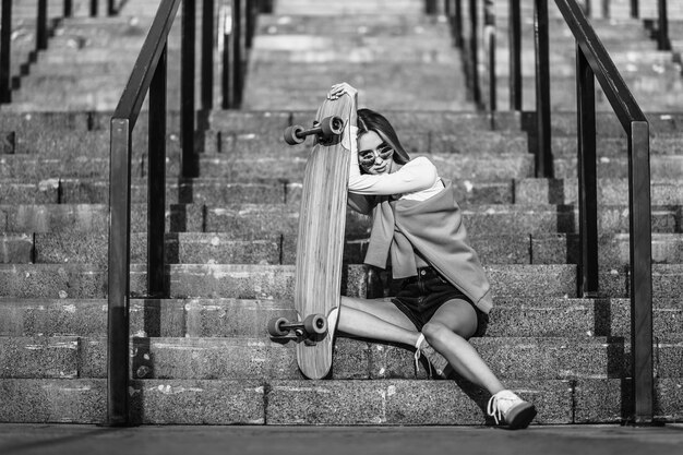 Woman with a skate sitting on the stairs. High quality photo