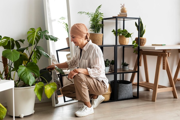 Woman with skin cancer taking care of her plants