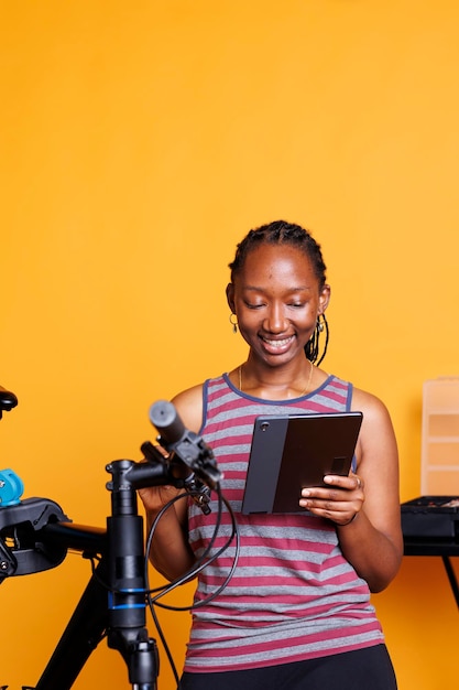 Woman with smart tablet for bike repair