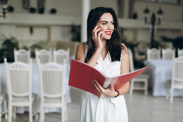 Woman with smartphone and menu folder