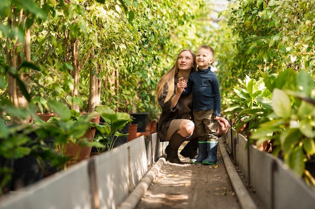 Woman with son on walk in the greenhouse