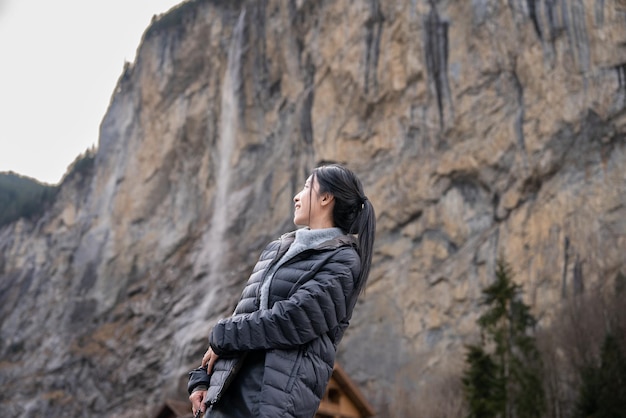 Woman with Staubbach Falls Kirche nature during winter in Lauterbrunnen Switzerland