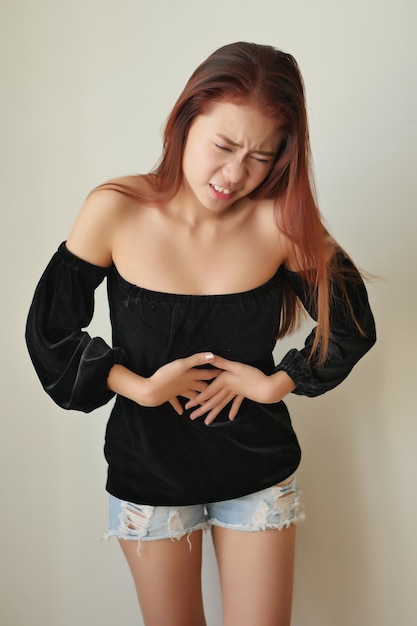 Woman with stomach ache, menstrual period cramp, abdominal pain, food poisoning