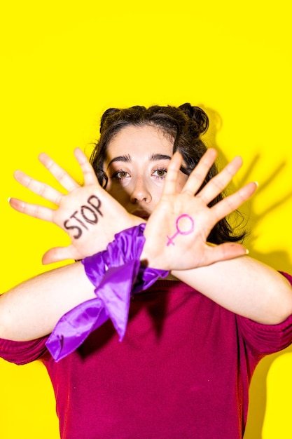 Woman with STOP Written on Palm for Womens Rights