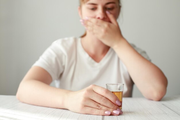 Woman with strong alcohol closes her mouth female alcoholism depression