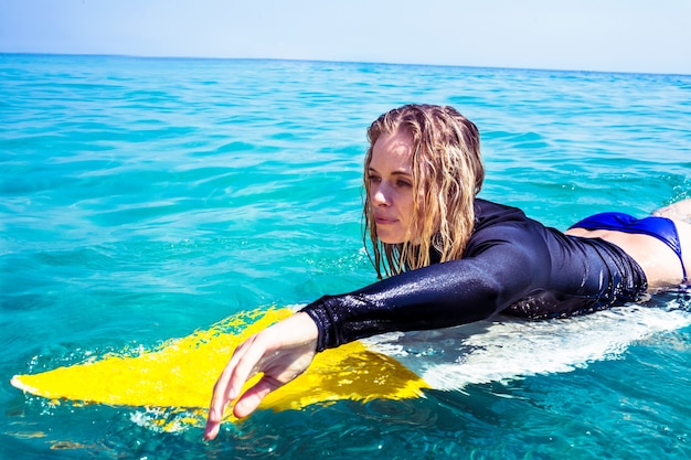 Woman with a surfboard on a sunny day