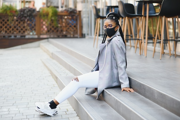 Woman with surgical mask outdoors