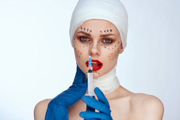 Woman with a syringe injections of beauty beauty portrait in the studio on a white background