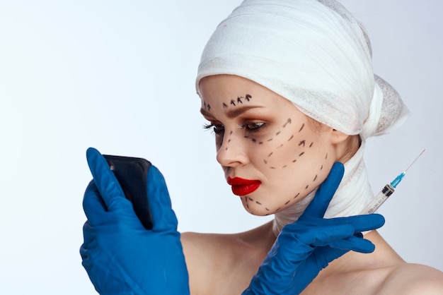 Woman with a syringe injections of beauty beauty portrait in the studio on a white background