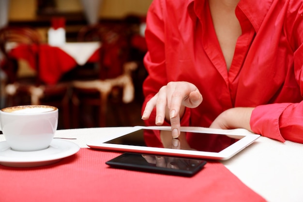 Woman with tablet computer in cafe shop