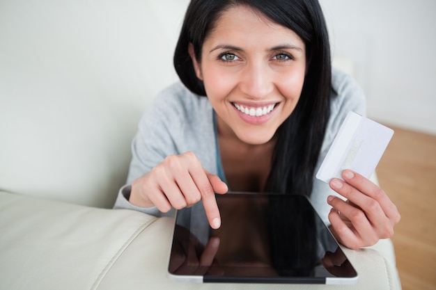 Woman with a tactile tablet and a credit card