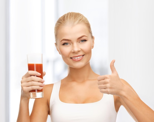 woman with tomato juice and showing thumbs up