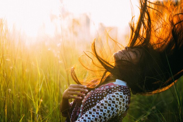 woman with tousled hair on field