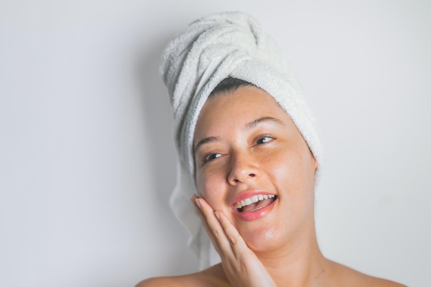 a woman with a towel on her head is smiling