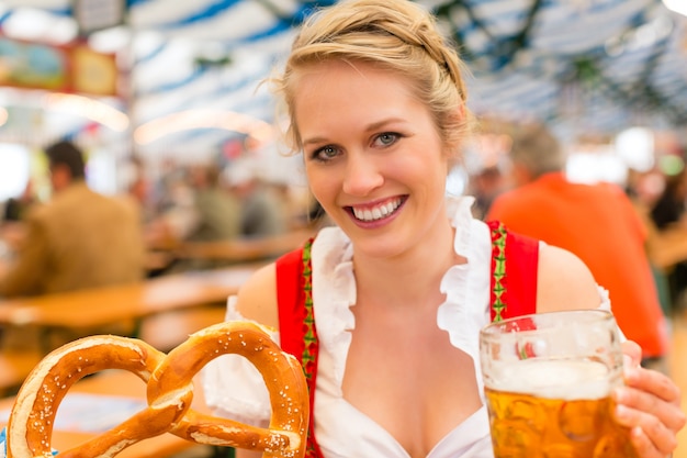 Woman with traditional Bavarian clothes or dirndl in beer tent