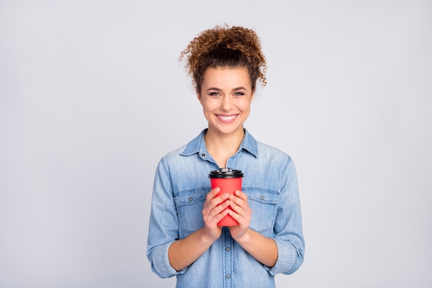 woman with trendy hairstyle holding coffee