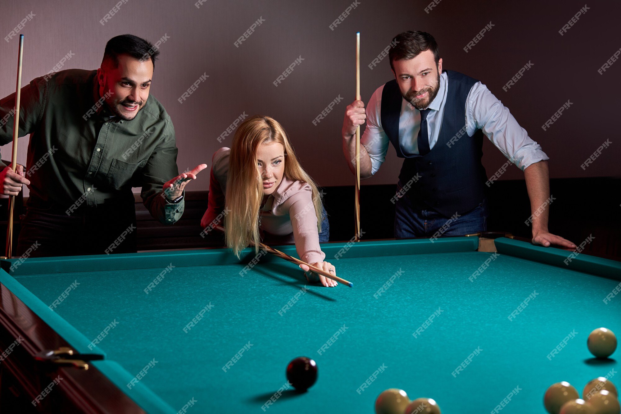 Friends Cheering While Their Friend Aiming For Billiards Ball