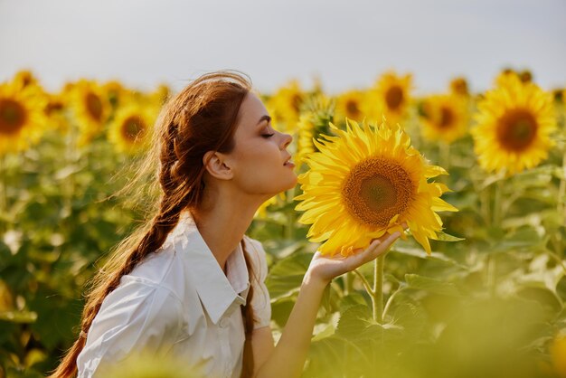 Woman with two pigtails in a field of sunflowers countryside