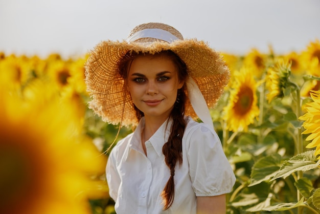 Woman with two pigtails in a white dress walking on a field of sunflowers unaltered