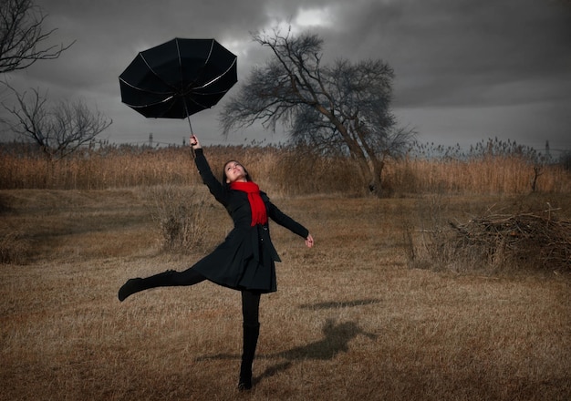 Photo woman with umbrella turning inside out by the wind