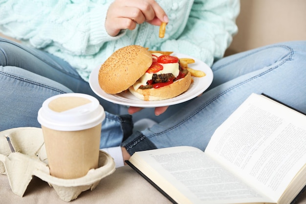 Woman with unhealthy fast food closeup