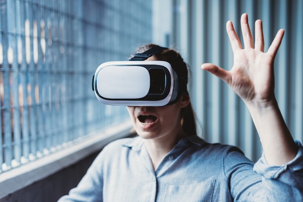 woman with virtual reality goggles enjoying virtual experience