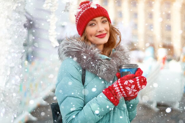 Woman with warm winter jacket stands outdoors