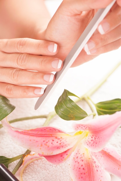 Woman with well manicured nails on white